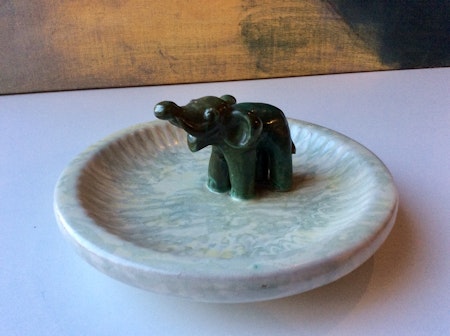 Green elephant in grey bowl