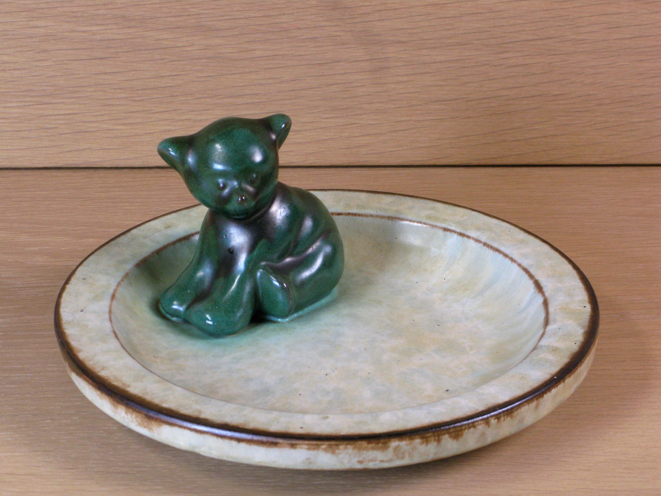 Sitting green bear in a bowl sold