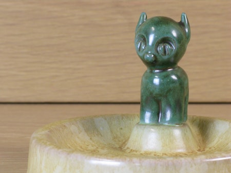 Green cat in a bowl
