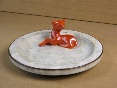 orange deer in greyish ashtray 46