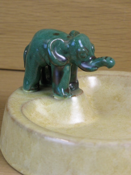 green elephant on yellowish bowl