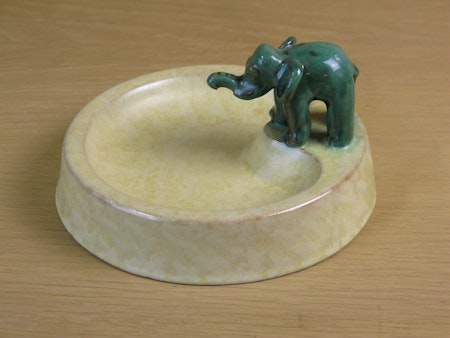 green elephant on yellowish bowl