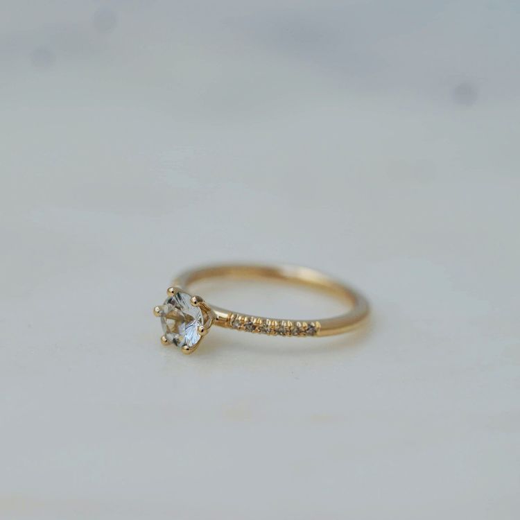 "Andromeda" in gold with a white sapphire and small diamonds