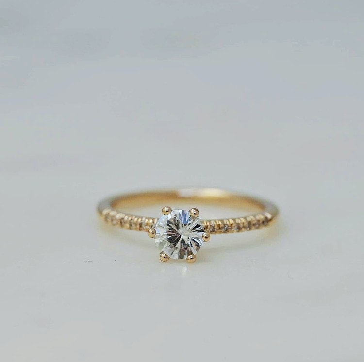 "Andromeda" in gold with a white sapphire and small diamonds