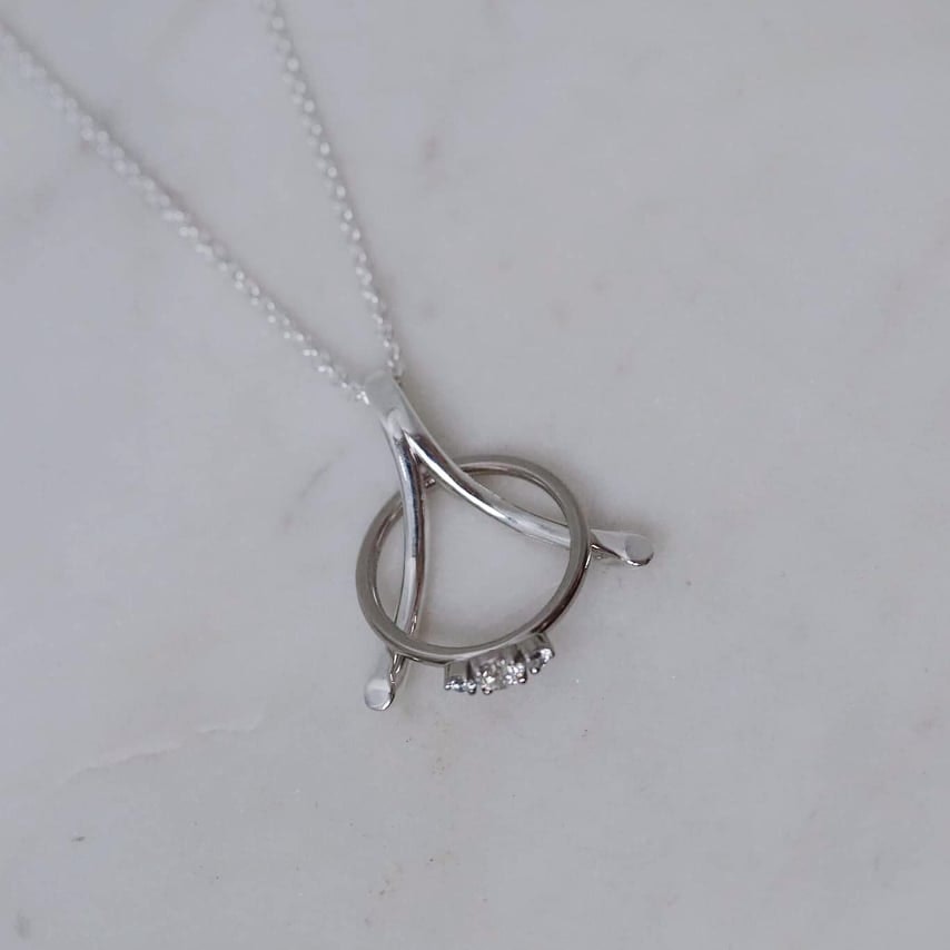 "Wishbone" ring holding necklace in silver