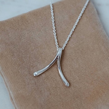"Wishbone" ring holding necklace in silver