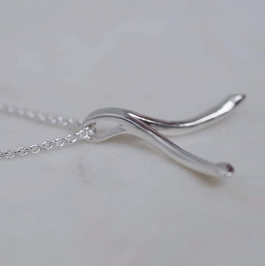 "Wishbone" ring holding necklace in silver