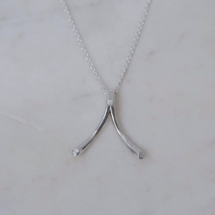 "Wishbone" ring holding necklace in silver