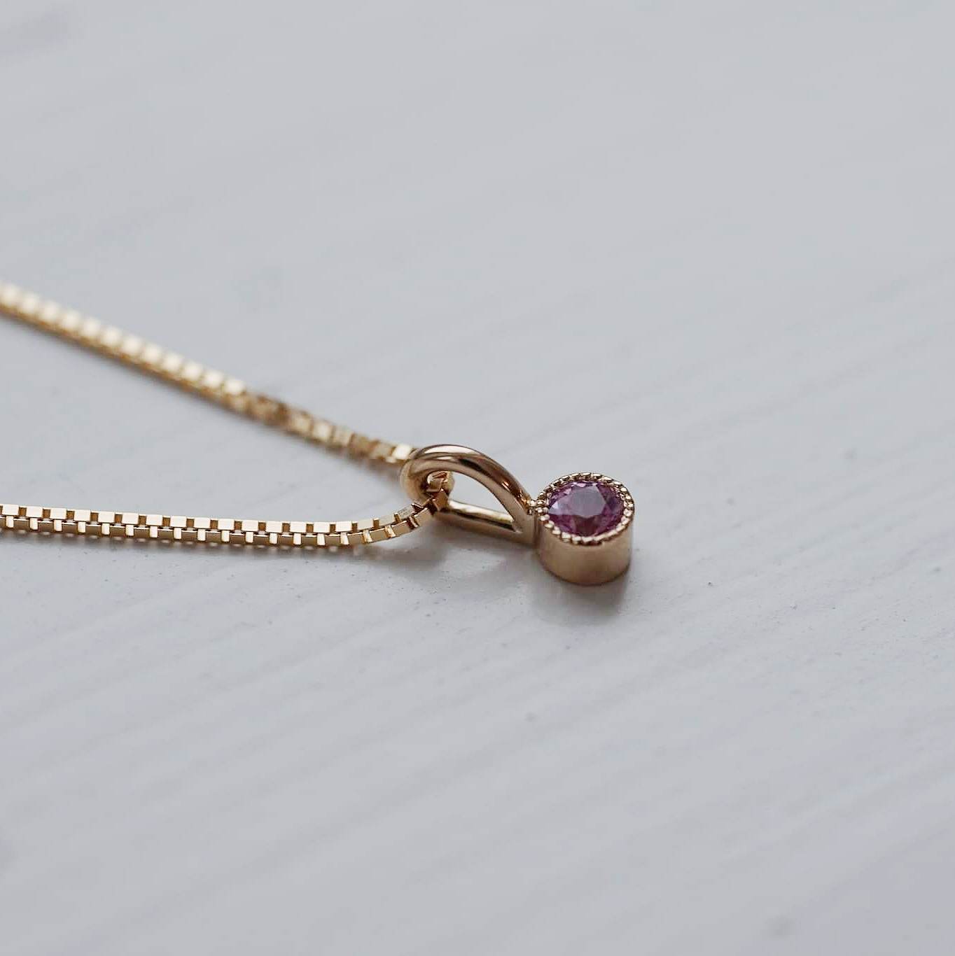 "Twinkle" pendant in gold with a light pink sapphire
