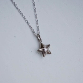 "Star" pendant in white gold with a small diamond