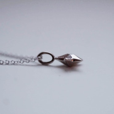 "Star" pendant in white gold with a small diamond