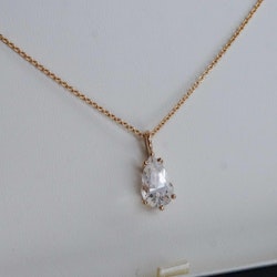 "Swedish Ice" pendant in gold with a pear cut crystal quartz from Riksgränsen
