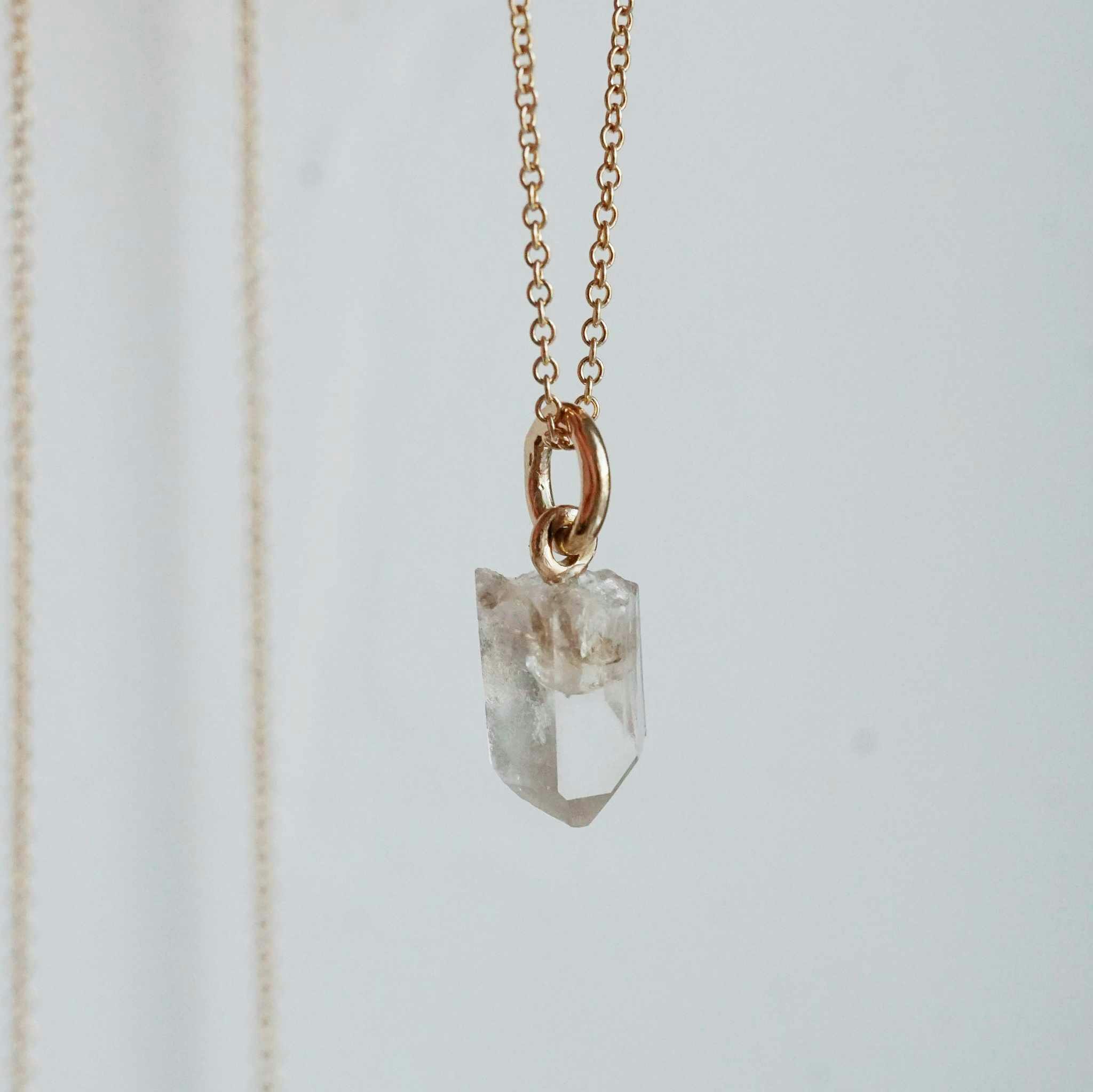 "Swedish Ice" Pendant in gold with a raw Swedish rock crystal
